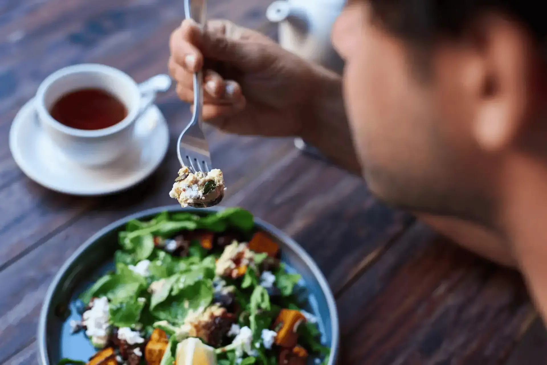 A man eating salad