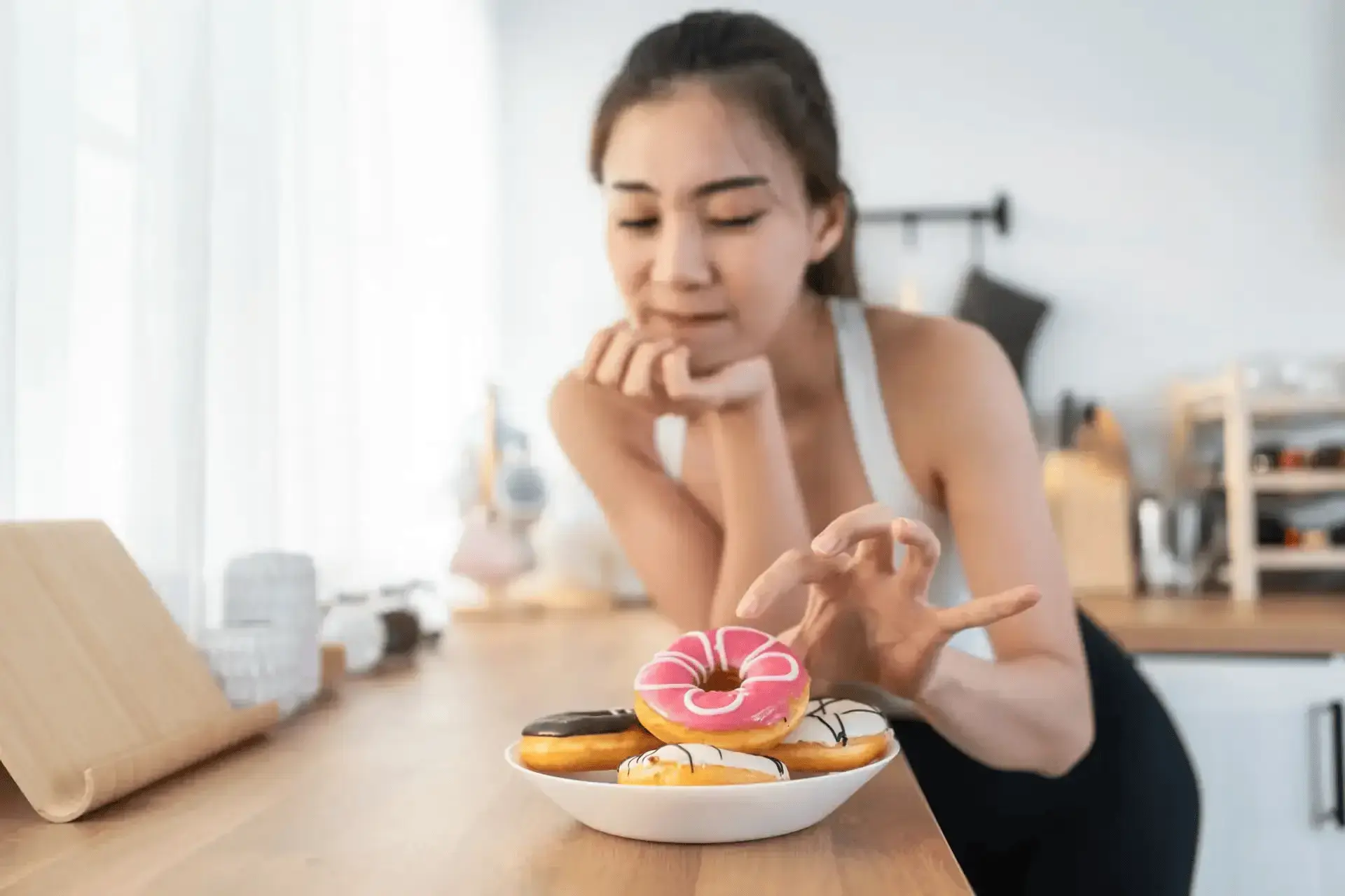 A woman tempted to eat a donut