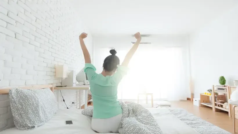Young Woman Stretching on the bed