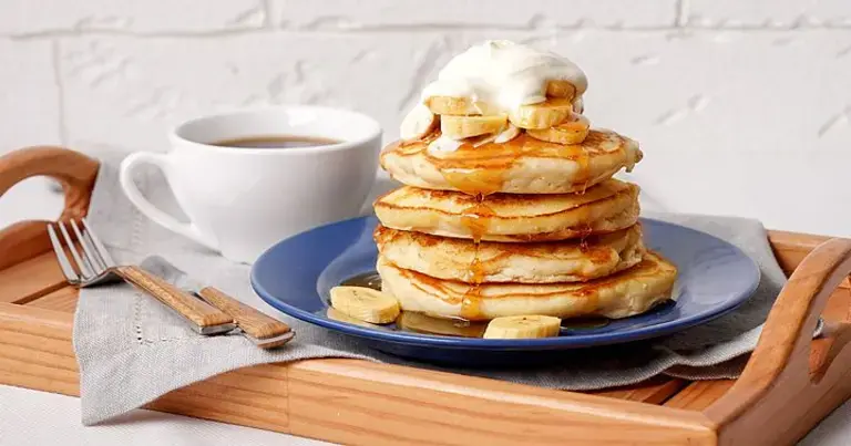 layers of banana pancake with honey and cream