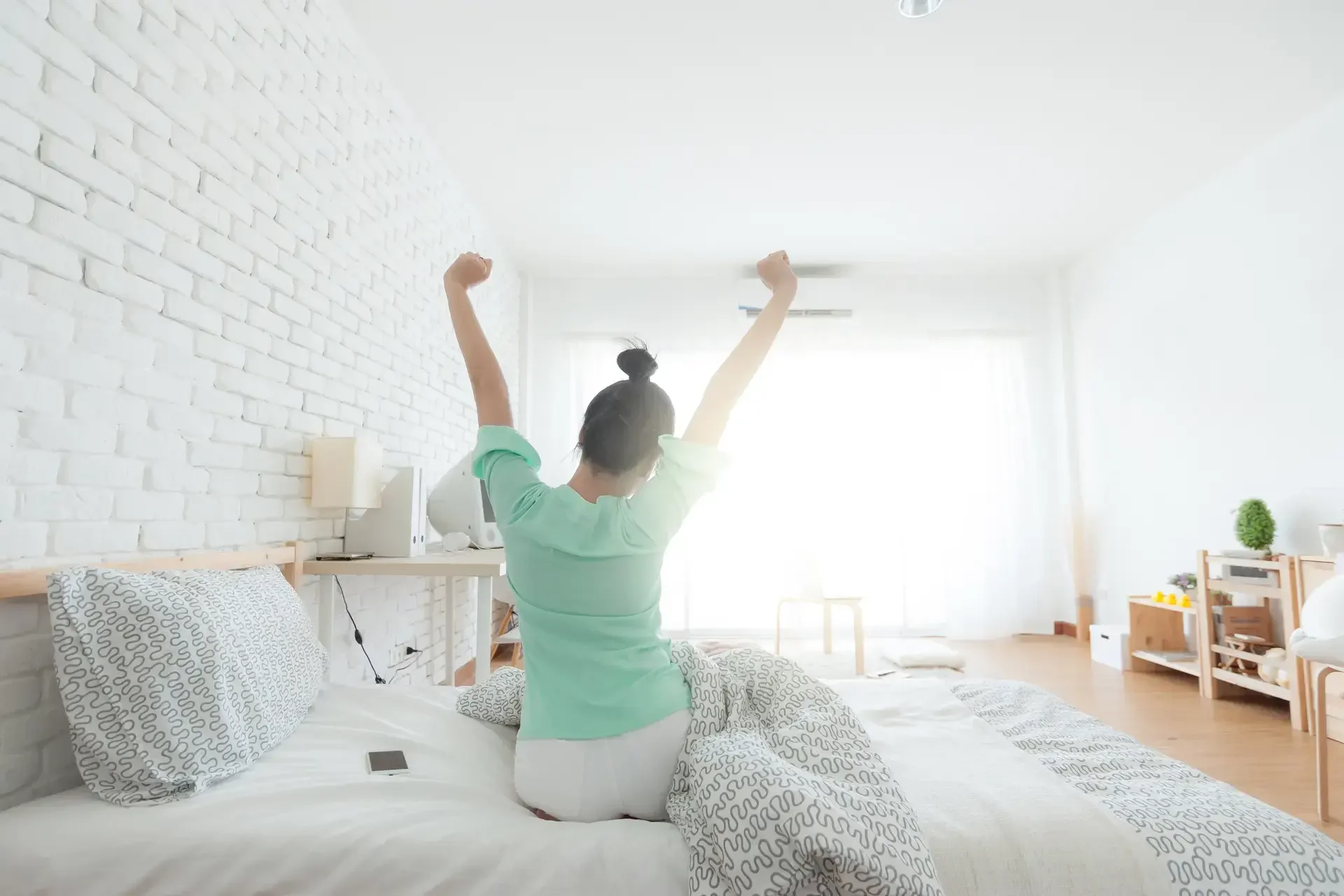 Young Woman Stretching on the bed