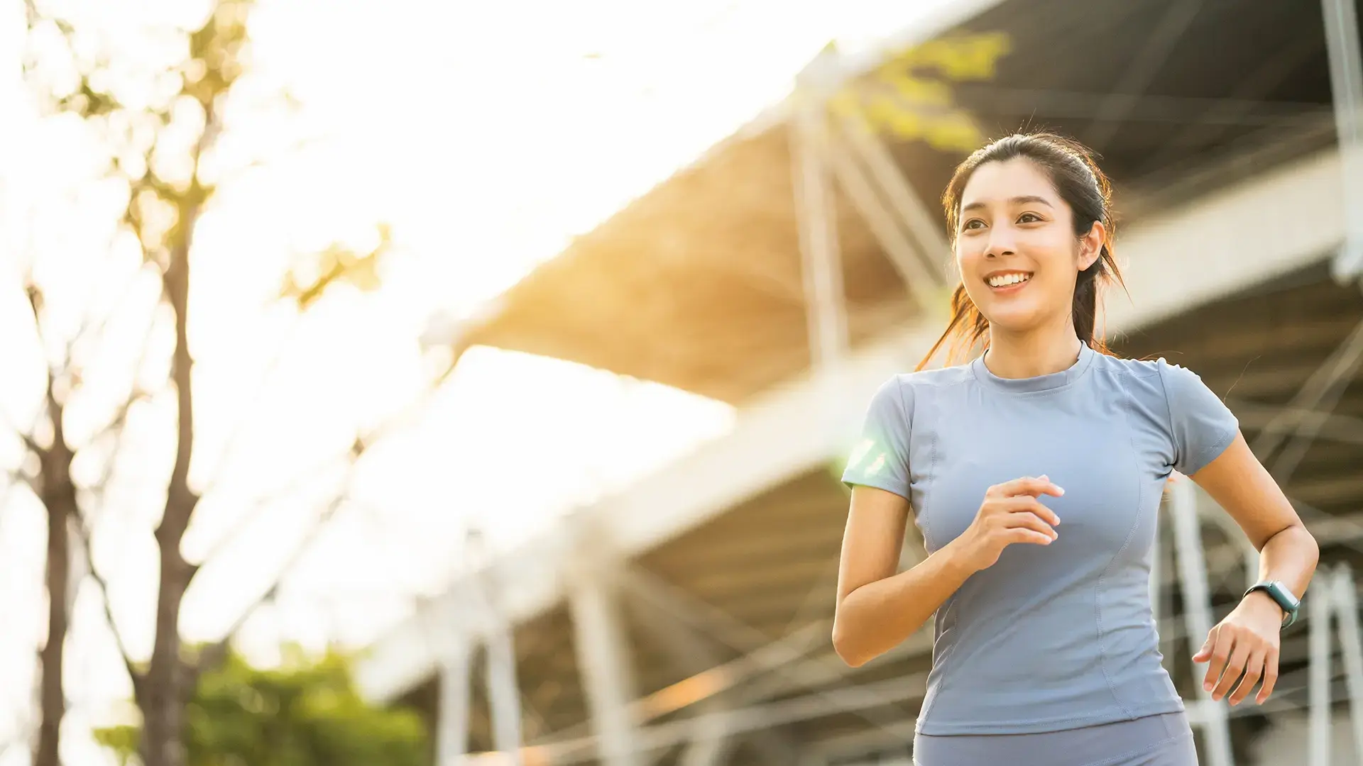 Attractive beautiful woman wearing sportswear running at sport stadium