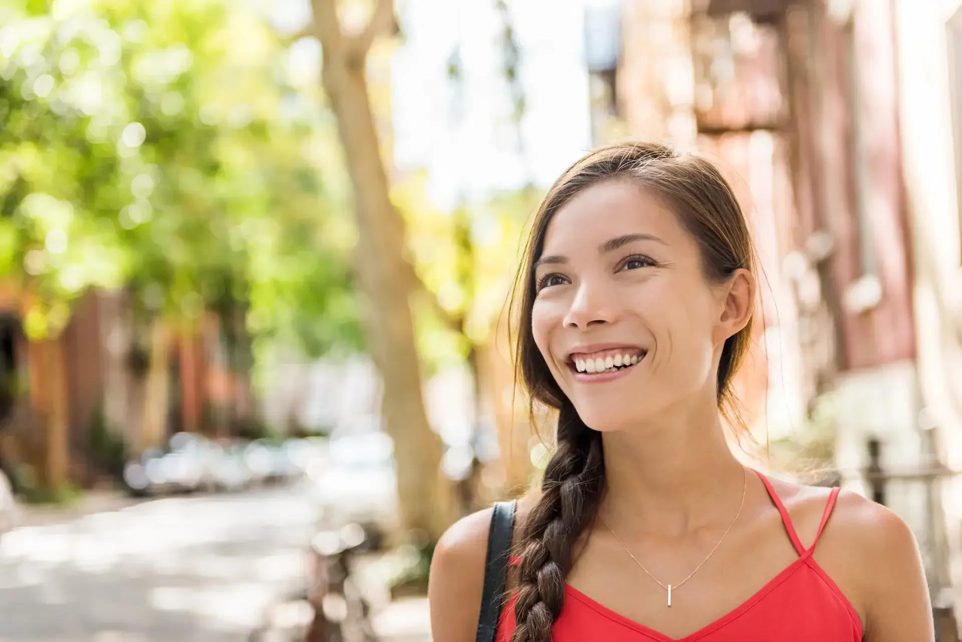 Happy asian woman relaxing enjoying weekend walk in her residential neighborhood