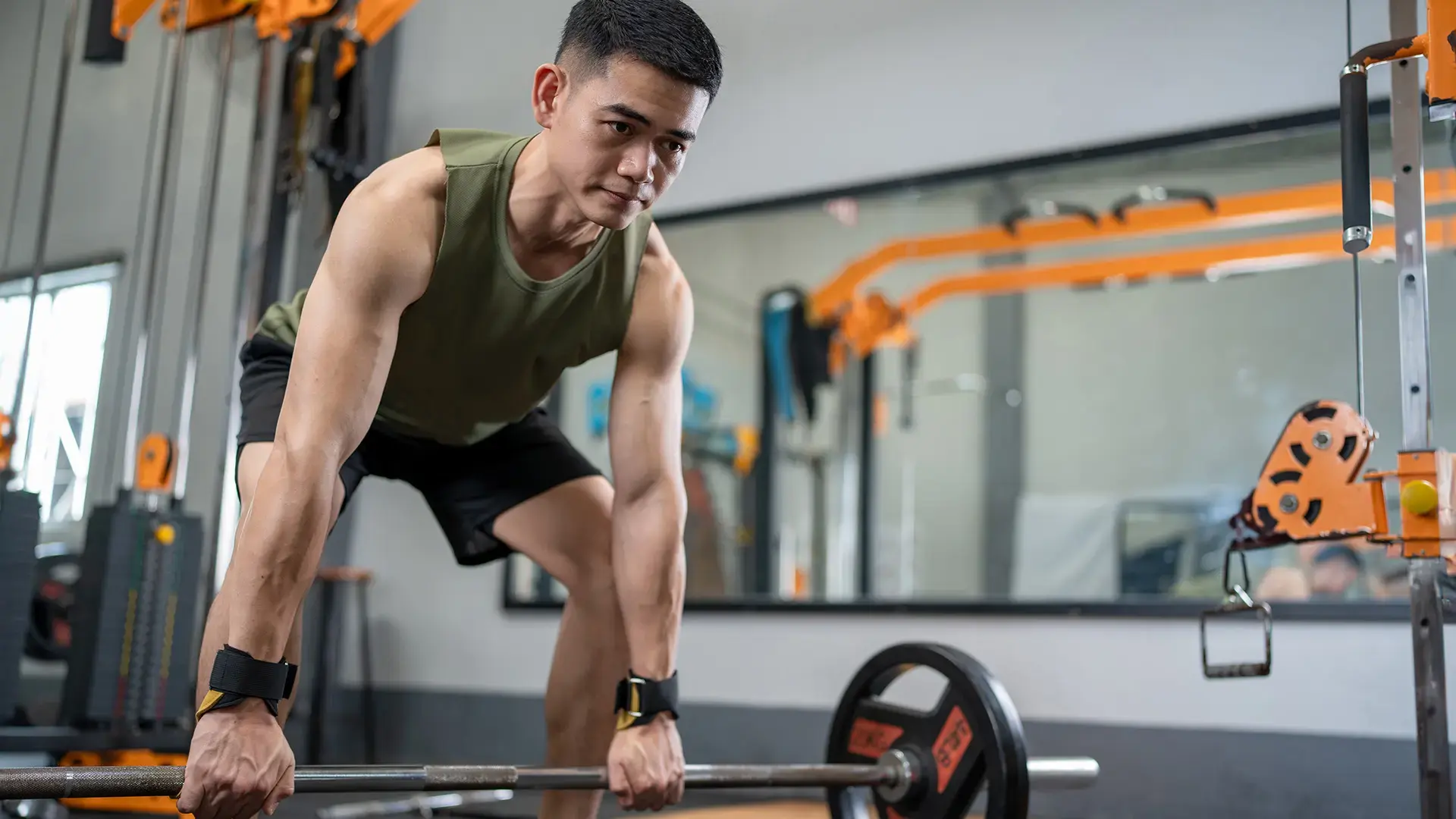 Young man lifting weights and exercising