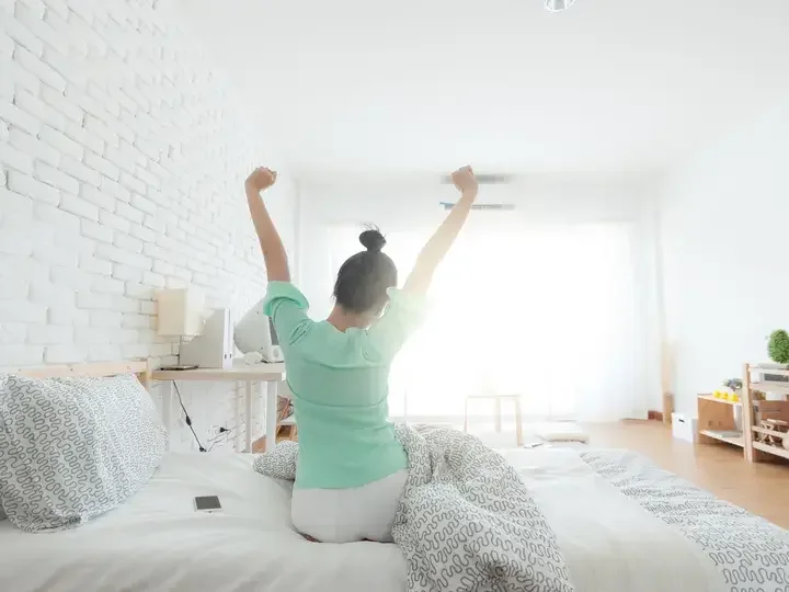 Young Woman Stretching on the bed