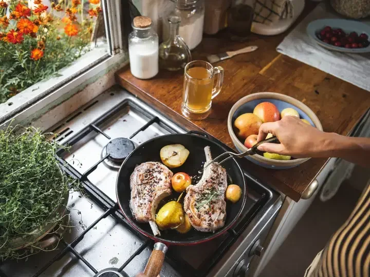 Chef cooking steak in a kitchen food photography recipe idea
